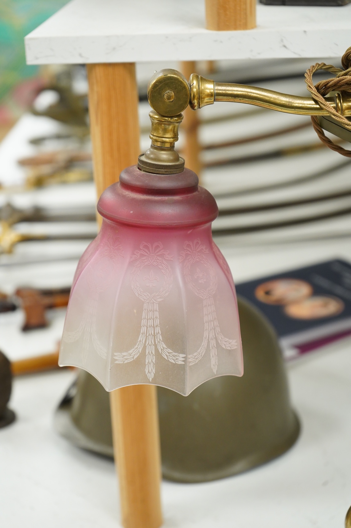A late Victorian brass desk light with cranberry shade, 59cm